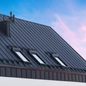 Long run roofing is intalled on a house with skylights.